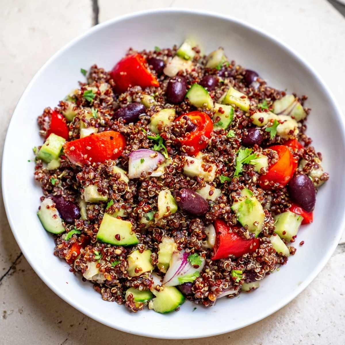 Refreshing Quinoa and Black Bean Salad is a colorful bowl with avocado and lime dressing.
