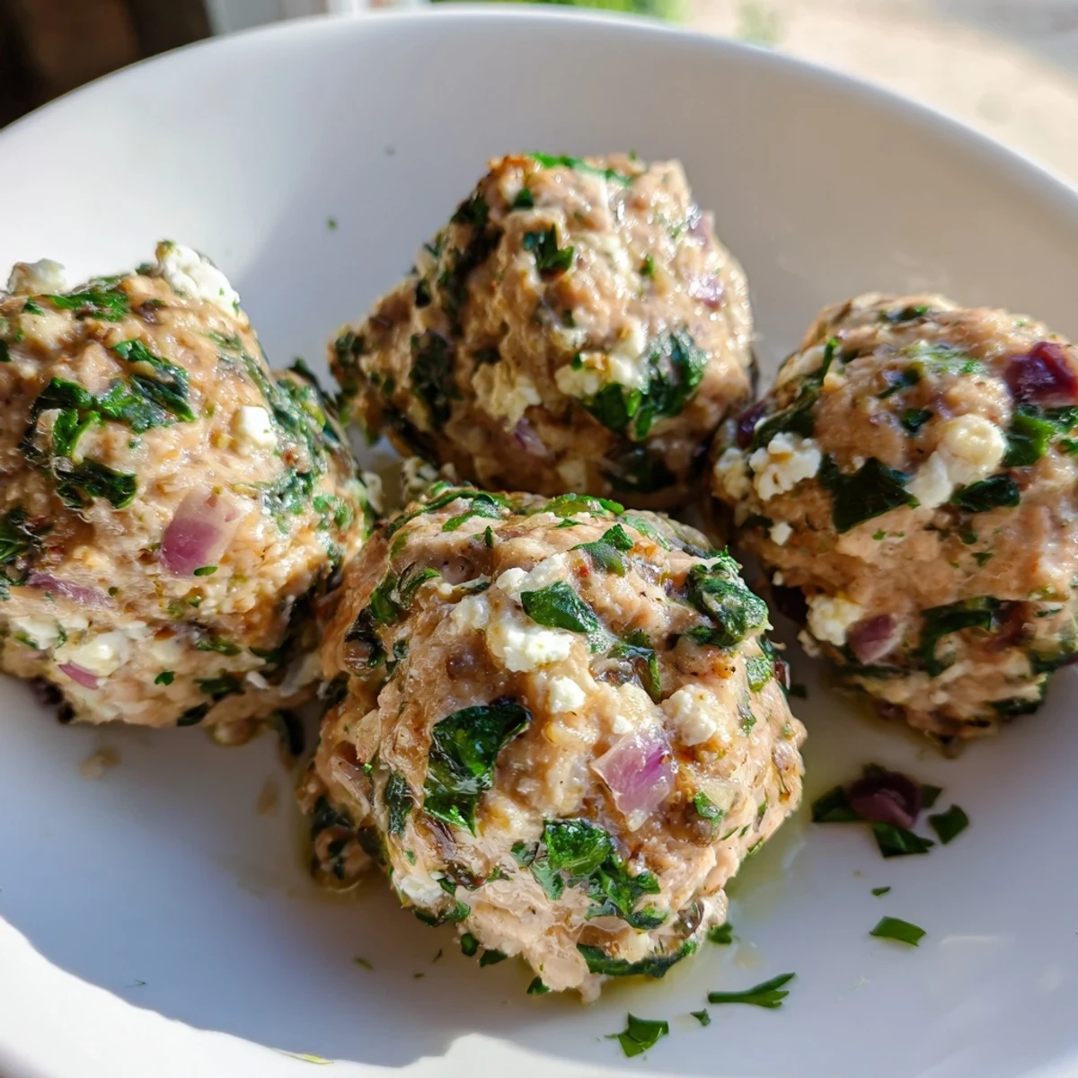 A close-up of baked spinach feta turkey meatballs, savory and aromatic, perfect for a balanced meal.
