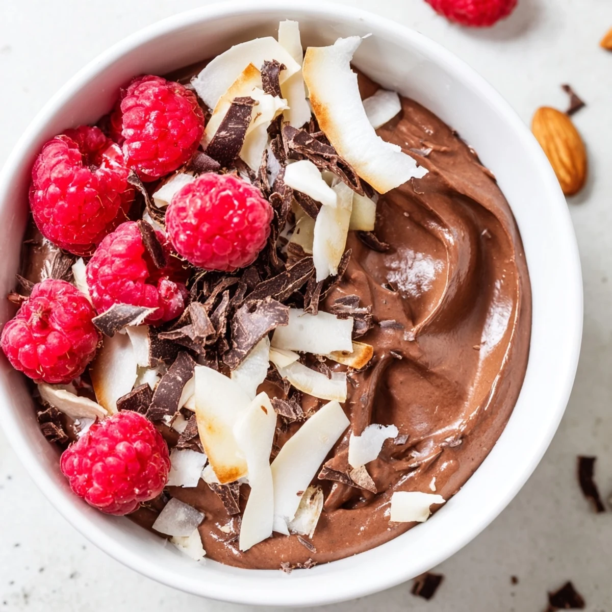 A silky-smooth chocolate avocado mousse, topped with fresh berries, ready to serve.