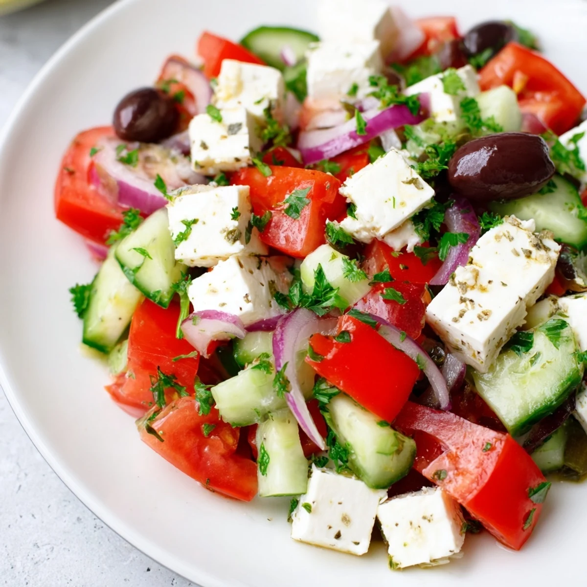 Vibrant, colorful Mediterranean Salad with juicy tomatoes and creamy feta cheese ready to enjoy.