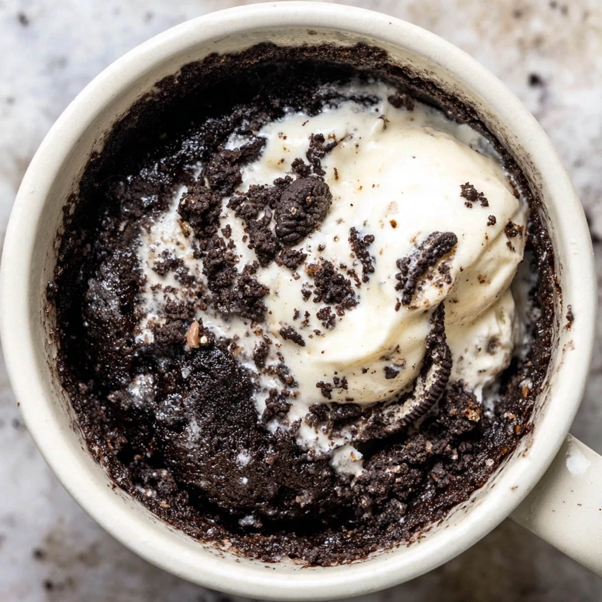 Enjoy a moist, indulgent Oreo Mug Cake, hot from the microwave with whipped cream!