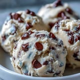 Creamy Greek Yogurt Cookie Dough in a glass jar, topped with chocolate chips and a vanilla bean.