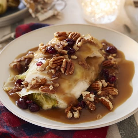 Tender, caramelized Winter Roasted Brussels Sprouts, ready to serve with toasted pecans and cranberries.