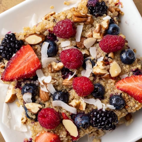 Freshly baked Berry Quinoa Breakfast Bake, showing juicy berries nestled within a creamy quinoa base.
