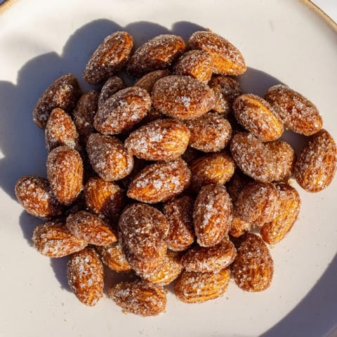 Crispy cinnamon roasted almonds, fresh from the oven, ready to be enjoyed as a tasty treat.