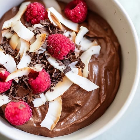 Dark, decadent chocolate avocado mousse, creamy textured, perfect for a vegan dessert experience.