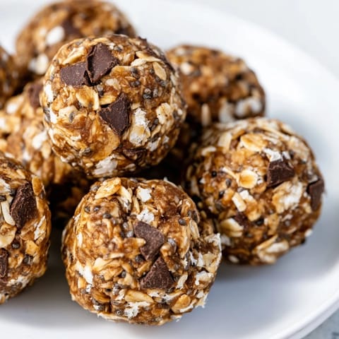 Round, no-bake Almond-Chia Energy Bites stacked on a tray, a perfect and healthy snack option.