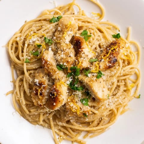 A close-up of Brown Butter Lemon Chicken Pasta with nutty butter, bright lemon zest, and grated Parmesan over twirled spaghetti.