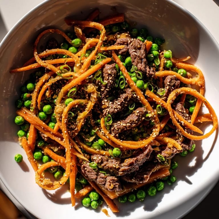 This delicious Skillet Beef Stir-Fry shows seared beef and colorful vegetables coated in a rich, glossy sauce.