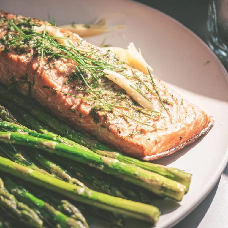 This beautiful plate features the Easy Herb-Crusted Salmon glistening with herbs, next to tender asparagus.
