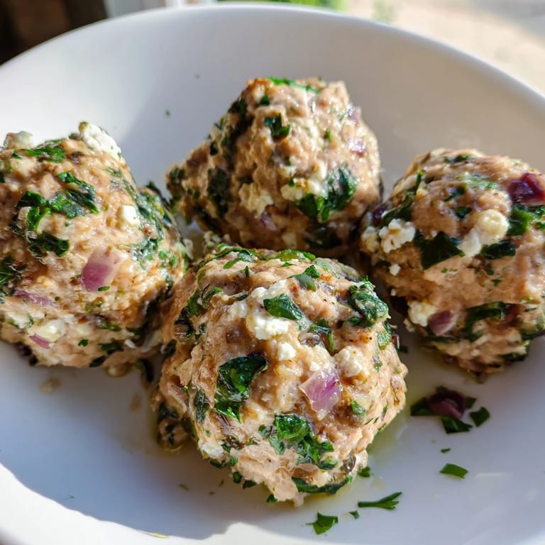 A close-up of baked spinach feta turkey meatballs, savory and aromatic, perfect for a balanced meal.