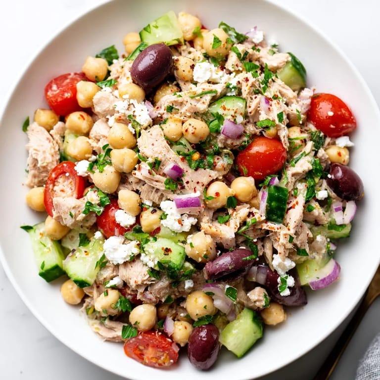 Freshly tossed Tuna Chickpea Salad with a zesty lemon dressing, ideal for a light meal on a warm day.