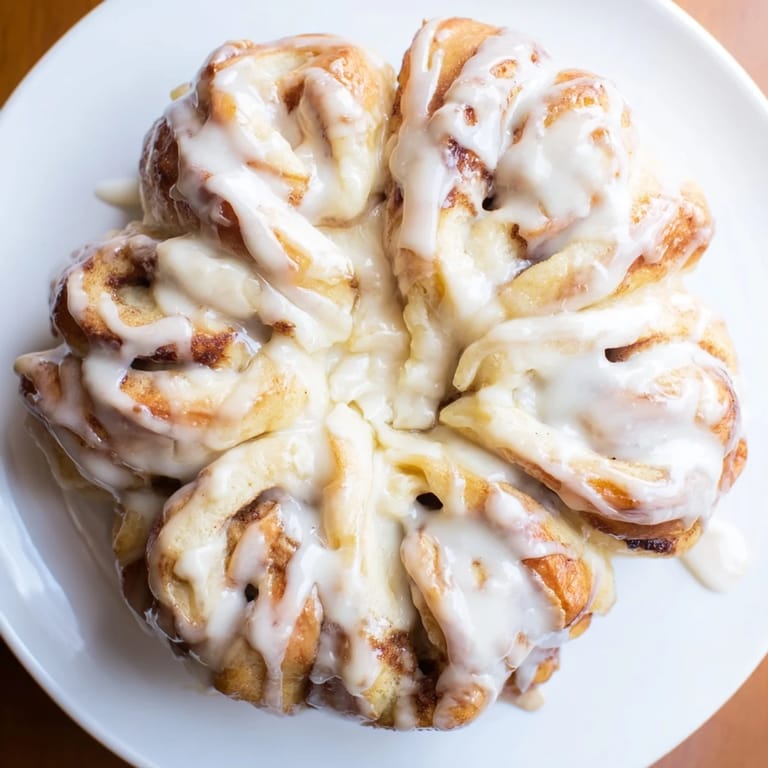 A close-up of the delicious Cinnamon Roll Pull-Apart Snowflake, freshly baked and drizzled with icing.
