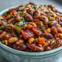 Hearty Black-Eyed Pea Chili simmering in a pot, packed with corn and diced vegetables for a comforting meal.