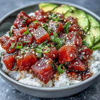 Vibrant Spring Tuna Poke Bowl bursting with fresh vegetables and zesty ponzu dressing.
