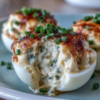 Crab cake deviled eggs with Old Bay seasoning, a savory appetizer delight.